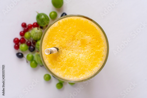 close up macro of fresh summer cooling fruit smoothie in glass with straw