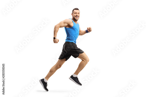 Young male in sportswear running and looking at the camera