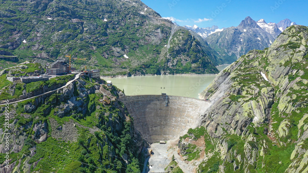 Dam at the glacier lakes in the Swiss Alps - aerial view