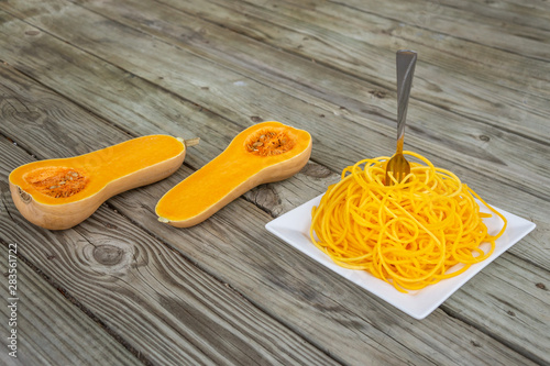 Butternut squash noodles with fork stuck in the middle of the pasta.