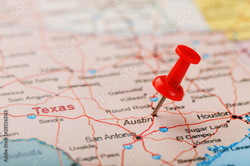 Red clerical needle on a map of USA, Texas and the capital Austin. Closeup Map Texas with Red Tack photo