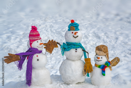 Greeting snowman family, parenthood concept. Snowman gifting. Gift emotions. Holiday poster design. Merry Christmas and happy new year greeting card with copy-space.
