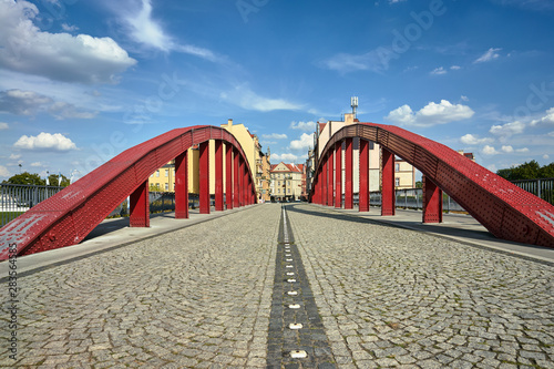 Steel structure of the bridge with a cobbled street in the city of Poznan.
