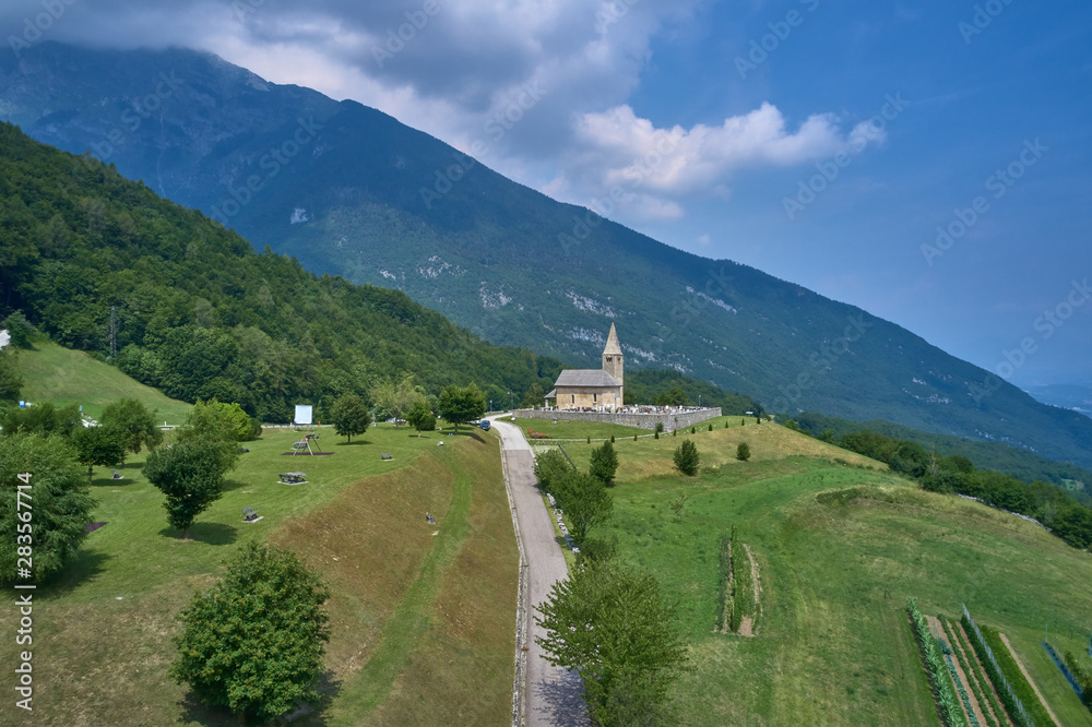 Aerial photography. Panoramic view of the Alps north of Italy. Trento Region. Great trip to the Alps. Cemetery is located on a hill.