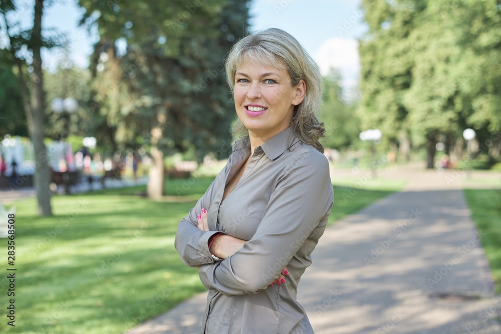 Outdoor portrait of positive mature middle-aged woman Outdoor portrait of positive mature middle-aged woman