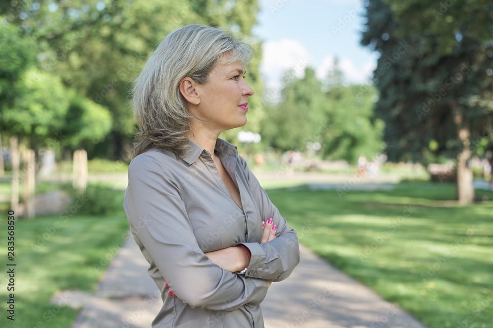 Outdoor portrait of positive mature middle-aged woman Outdoor portrait of positive mature middle-aged woman