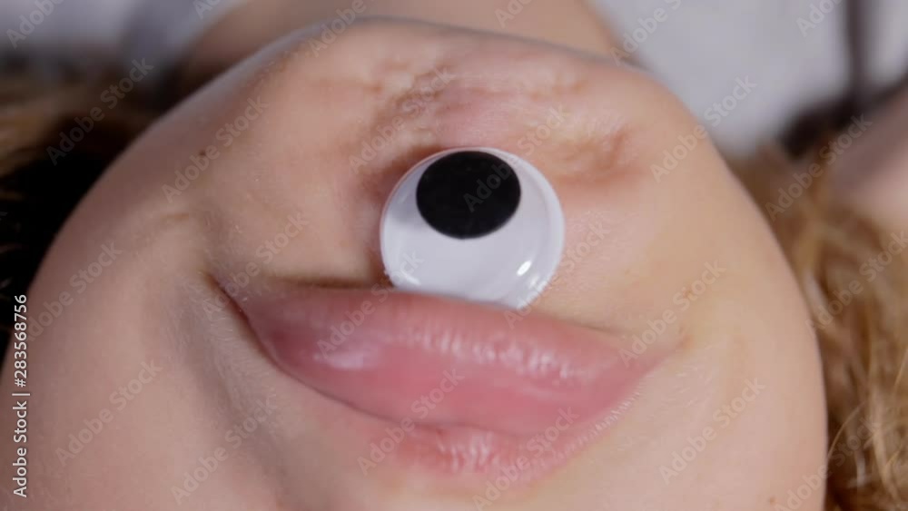 A funny wry face of a cyclops, made by sticking one single googly eye