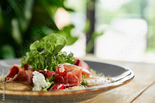 Side view of plate with delicious salad on table