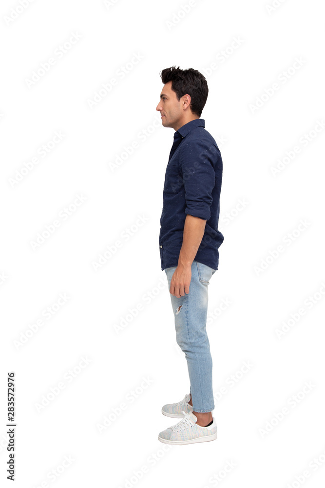 Side view of a young casual man standing isolated on white