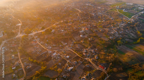 A beautiful village at sunrise, shot from above.