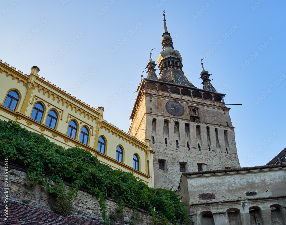 Clock tower or tower of the Town Hall and medieval architecture, at the entrance to the citadel of the historic center of the city of Sighisoara, in Romania, a UNESCO World Heritage Site