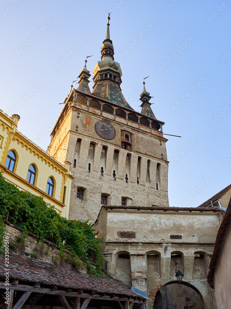 Clock tower or tower of the Town Hall and medieval architecture, at the entrance to the citadel of the historic center of the city of Sighisoara, in Romania, a UNESCO World Heritage Site