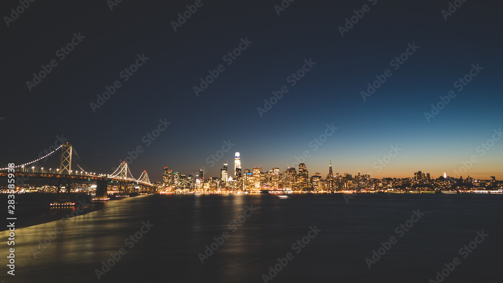 Panoramic beautiful scenic view of the Oakland Bay Bridge and the San Francisco city in the evening, California, USA