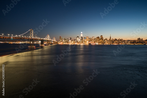 Panoramic beautiful scenic view of the Oakland Bay Bridge and the San Francisco city in the evening, California, USA © icephotography