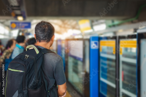 Male waiting subway train on platform, Public transport people travel commute city urban concept. man tourist watch metro drive leaving.