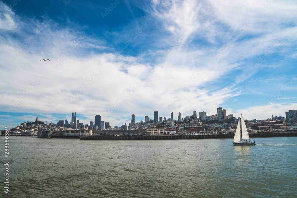 Panoramic symbolic view of San Francisco city from a boat tour on a sunny day with clear blue skies, California