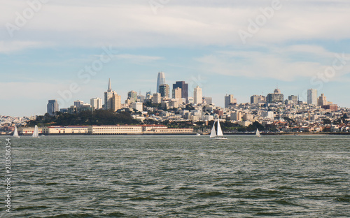 Panoramic symbolic view of San Francisco city and Financial District skyscrapers from a boat tour on a sunny day with clear blue skies, California © icephotography