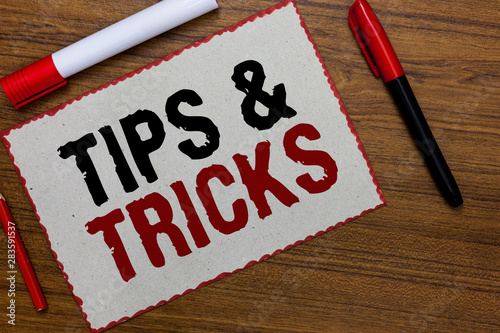Text sign showing Tips and Tricks. Conceptual photo Steps Lifehacks Handy advice Recommendations Skills White paper red borders markers wooden background communicating ideas photo