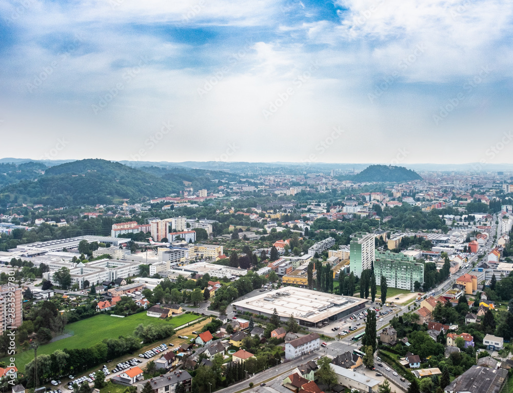 City Graz aerial view with district Gösting and hill Schloßberg