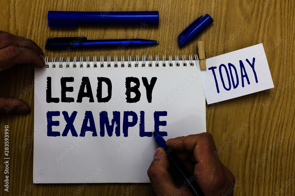 Handwriting text Lead By Example. Concept meaning Be a mentor leader follow the rules give examples Coach Man holding marker notebook clothespin reminder wooden table cup coffee Handwriting text Lead By Example. Concept meaning Be a mentor leader follow the rules give examples Coach Man holding marker notebook clothespin reminder wooden table cup coffee