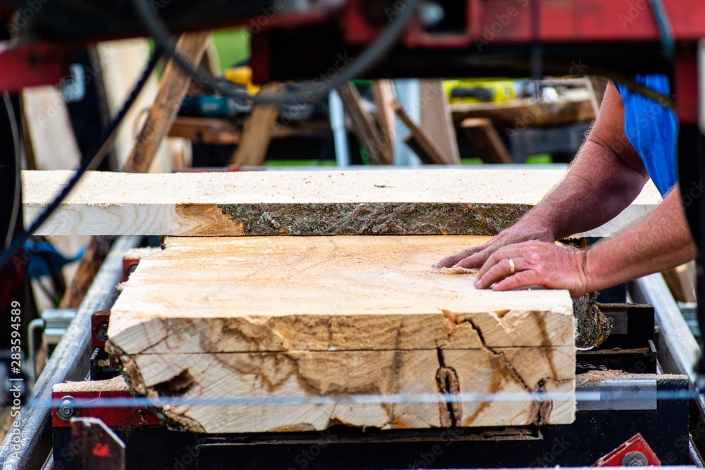 A mobile sawmill is setup at a local farm and livestock show in Ruckersville, VA. Boards are cut on site and sold to customers as they are needed. A mobile sawmill is setup at a local farm and livestock show in Ruckersville, VA. Boards are cut on site and sold to customers as they are needed.