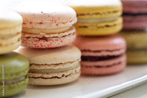 Colourful french macarons background, close up.Different colourful macaroons background.Tasty sweet colour macaron, Bakery concept.Selective focus.