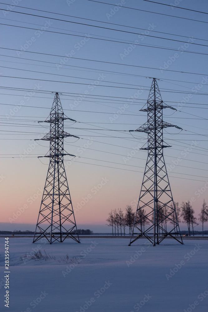 Power lines against the backdrop of winter dawn. Winter landscape. Dawn. Copy space. Power lines against the backdrop of winter dawn. Winter landscape. Dawn. Copy space.