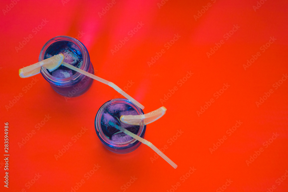 Two refreshing cocktails with lemon and straw Two refreshing cocktails with lemon and straw