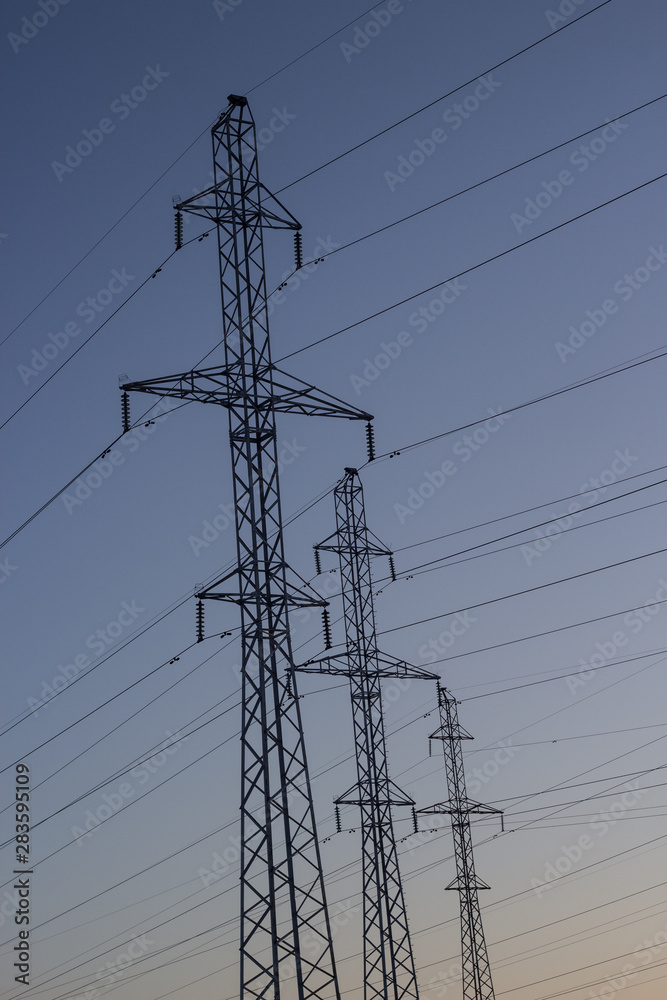 Power lines on a background of a winter sunset. Winter landscape. Copy space. Power lines on a background of a winter sunset. Winter landscape. Copy space.