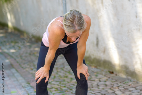 Fit muscular woman resting during a workout © michaelheim