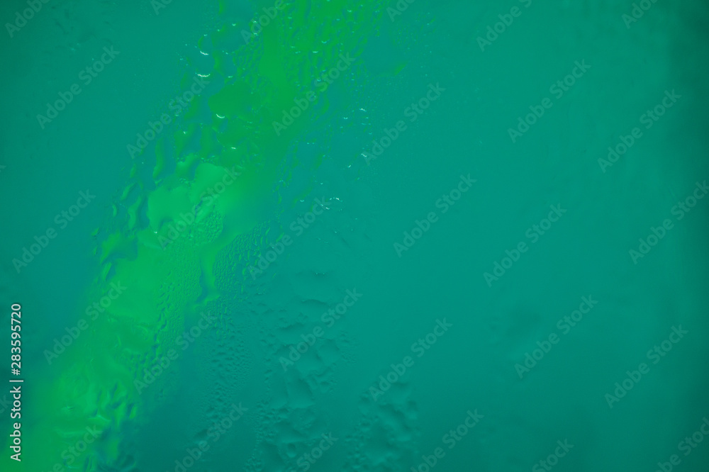 Drops of water close-up on a green background Drops of water close-up on a green background