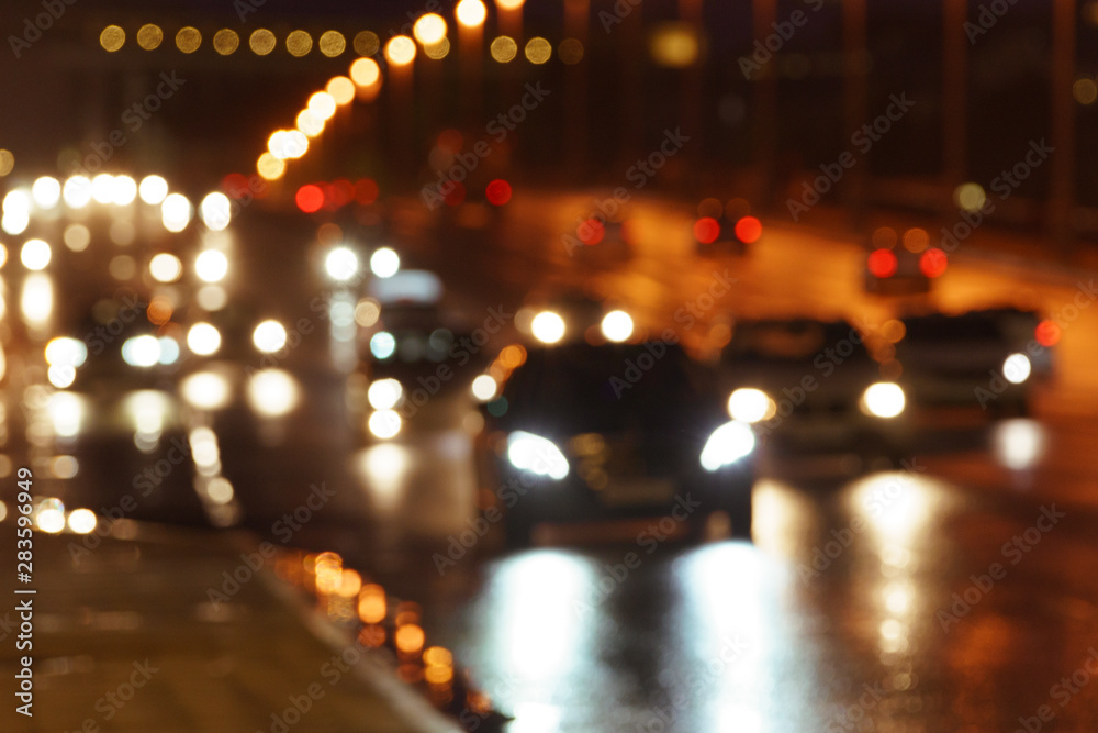 Defocused image of hard night for drivers. Big traffic in the city. In the summer urban highway filled cars. To be late. Long exposure. For greeting card design, postcard template, guide, poster. Defocused image of hard night for drivers. Big traffic in the city. In the summer urban highway filled cars. To be late. Long exposure. For greeting card design, postcard template, guide, poster.
