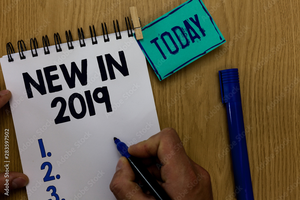 Word writing text New In 2019. Business concept for list of fresh things got introduced this year or the next Man holding marker notebook clothespin reminder wooden table cup coffee Word writing text New In 2019. Business concept for list of fresh things got introduced this year or the next Man holding marker notebook clothespin reminder wooden table cup coffee