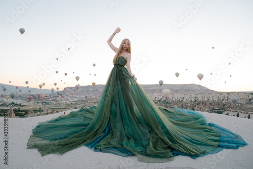 Woman in dress among balloons in cappadocia turkey