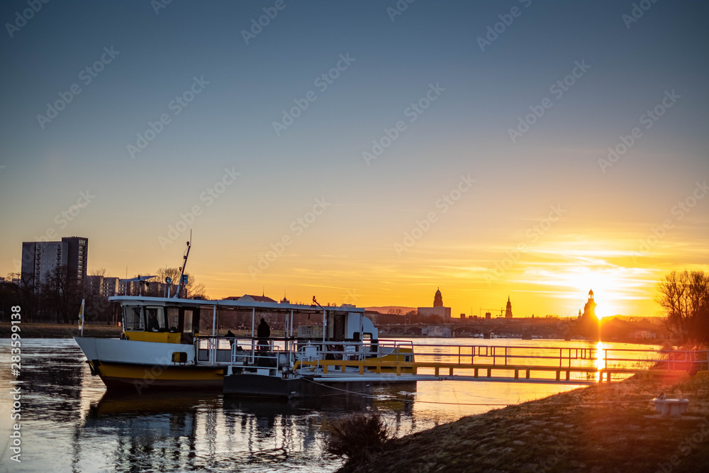 Fototapeta premium Ferry on Elbe River in Dresden Germany with Frauenkirche 