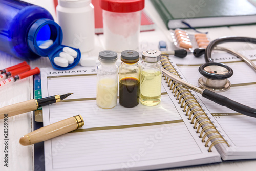 Ampoules and stethoscope on schedule on the table