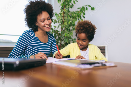 Mother and daughter doing homework learning to calculate