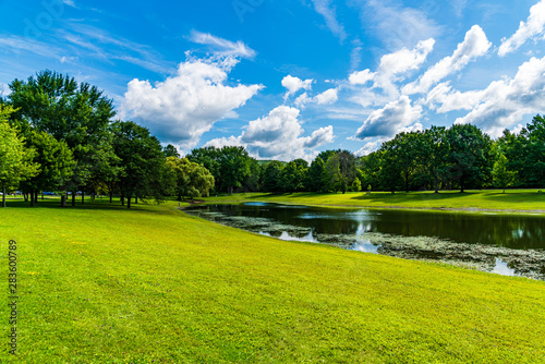 Park with lake and blue sky and clouds © Gerard