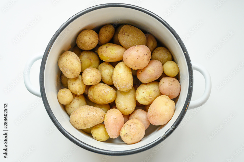 Boiled potatoes in their skins in a saucepan Boiled potatoes in their skins in a saucepan