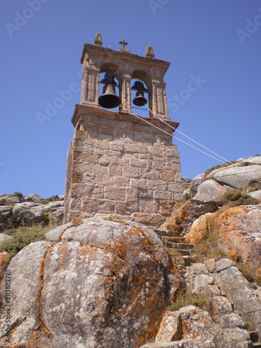 Picturesque bell tower of the parish of Santa Maria in Muxia. August 7, 2012. Muxia La Coruna Galicia, Spain. Vacation Nature Street Photography. photo