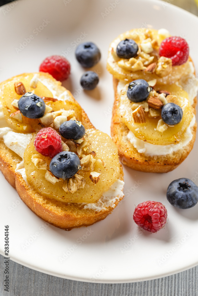 Toasts with pear, cream cheese, nuts and honey. Toasts with pear, cream cheese, nuts and honey.