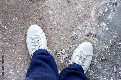 White shoes on a concrete slab background at a construction site.
