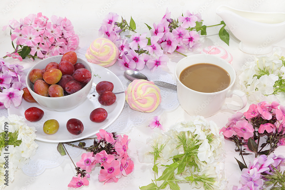Colorful pink phlox flowers, cups of coffee, fruits and marshmallows on a light table, top view, flat lay, selective focus. Pink flowers on a light background, a gift for loved ones, Colorful pink phlox flowers, cups of coffee, fruits and marshmallows on a light table, top view, flat lay, selective focus. Pink flowers on a light background, a gift for loved ones,