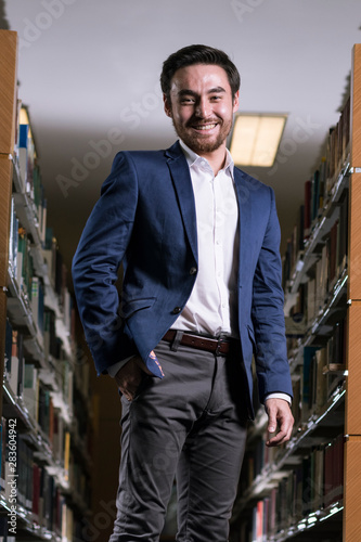 portrait of a man in suit in the library photo