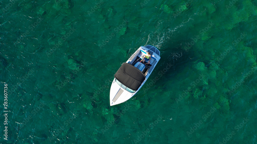 Aerial top view photo of traditional fishing boat in emerald crystal clear sea of Corfu island, Ionian, Greece