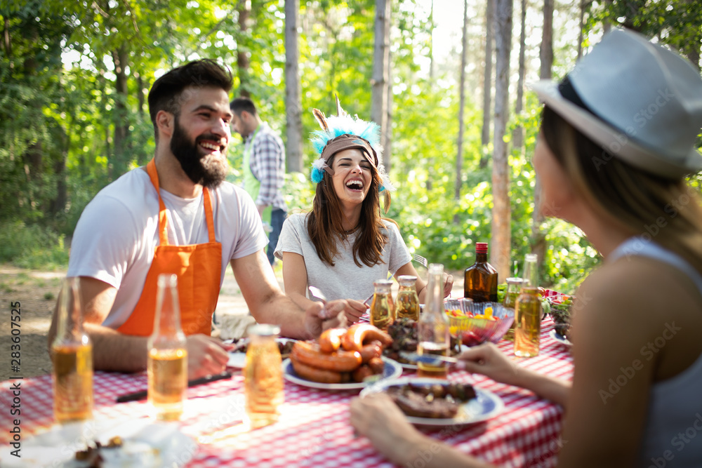 Group of friends having a barbecue party in nature