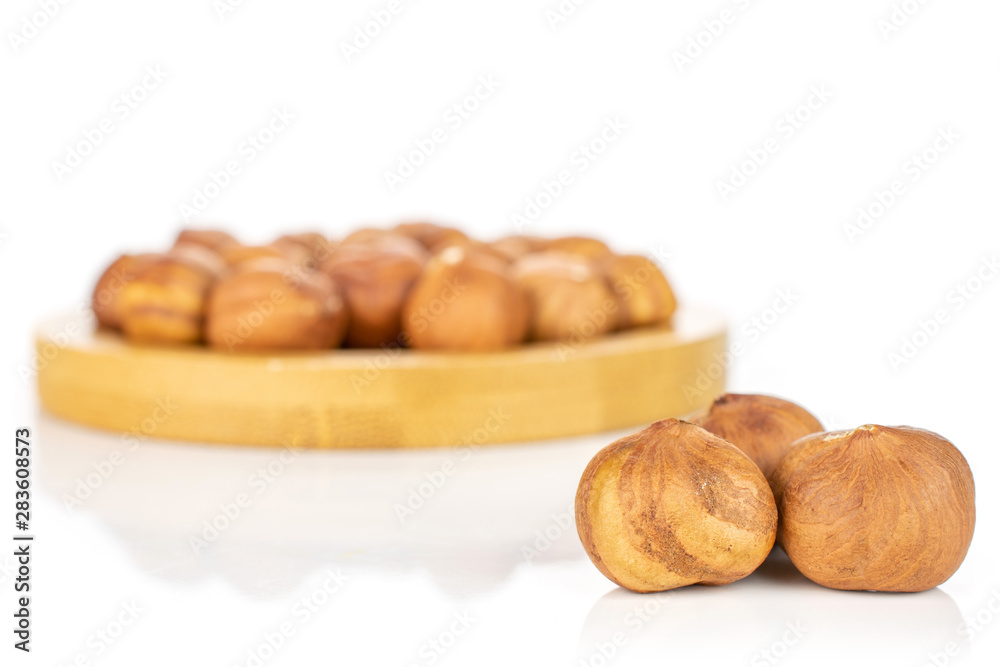 Lot of whole ripe brown hazelnut three are in the front and the rest is in the back isolated on white background Lot of whole ripe brown hazelnut three are in the front and the rest is in the back isolated on white background