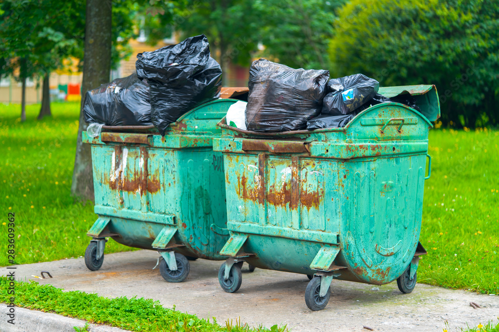 dumpsters on wheels old green rusty full of garbage packages dumpsters on wheels old green rusty full of garbage packages