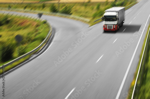 Truck driving fast with the trailer on the countryside road © Dmitry Perov