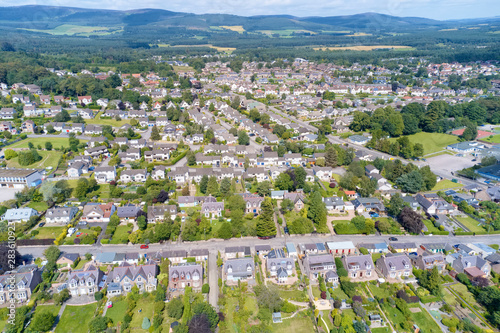 Suburban houses in row aerial view over Banchory in summer illuminating gardens photo